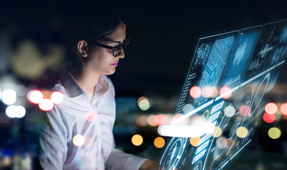 woman interacting with a futuristic screen displaying data and analytics