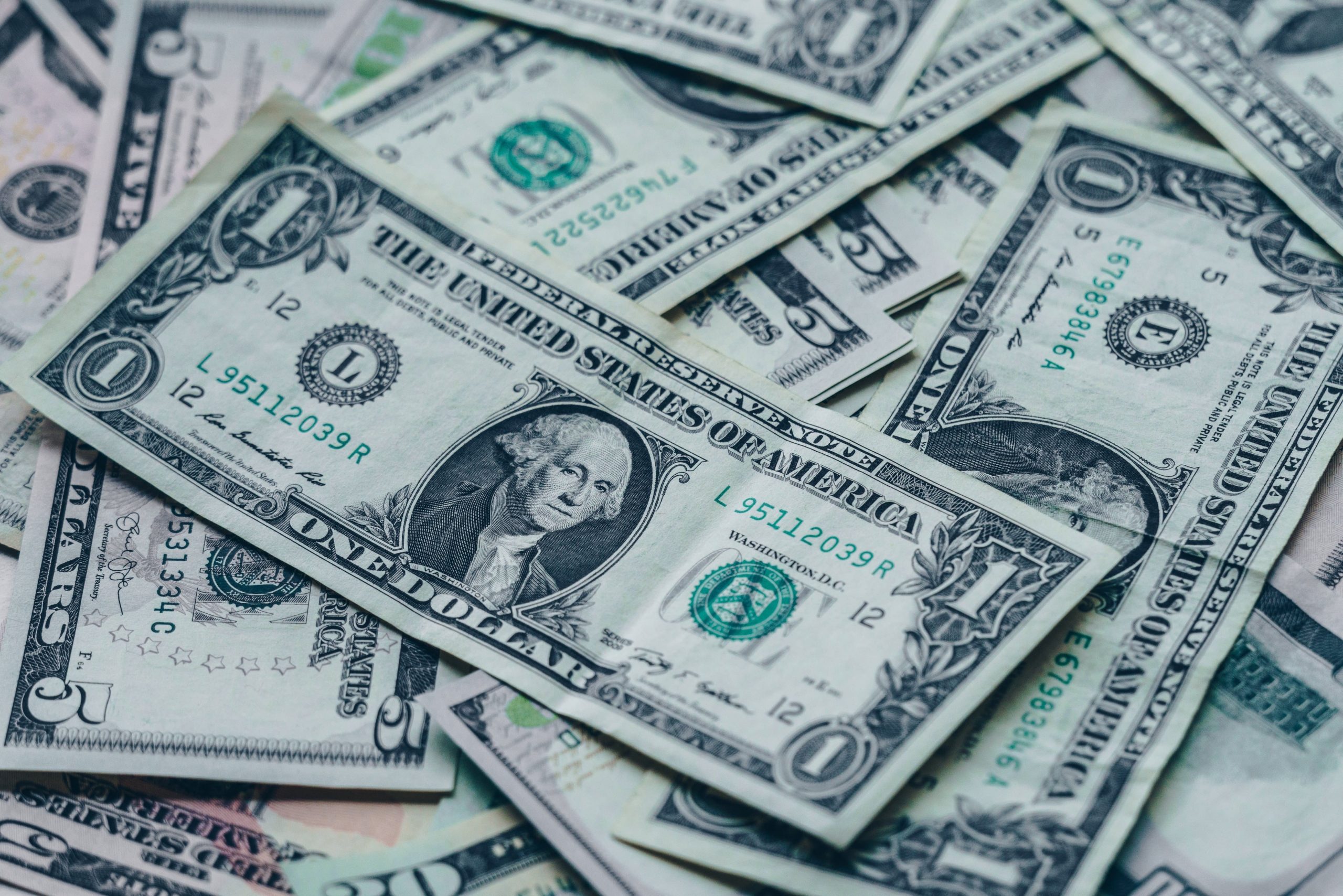 A photo of dollar bills splayed out on a surface
