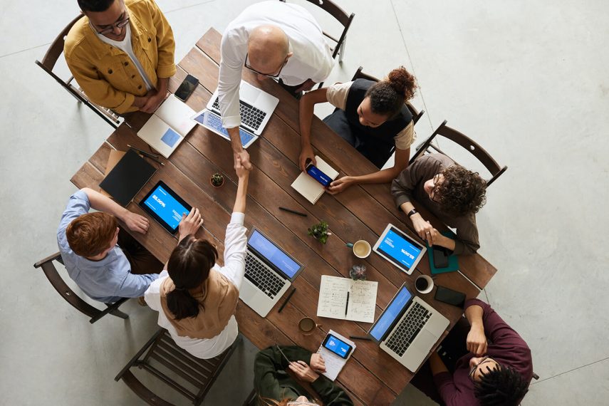 Corporate team meeting around a table working on a project