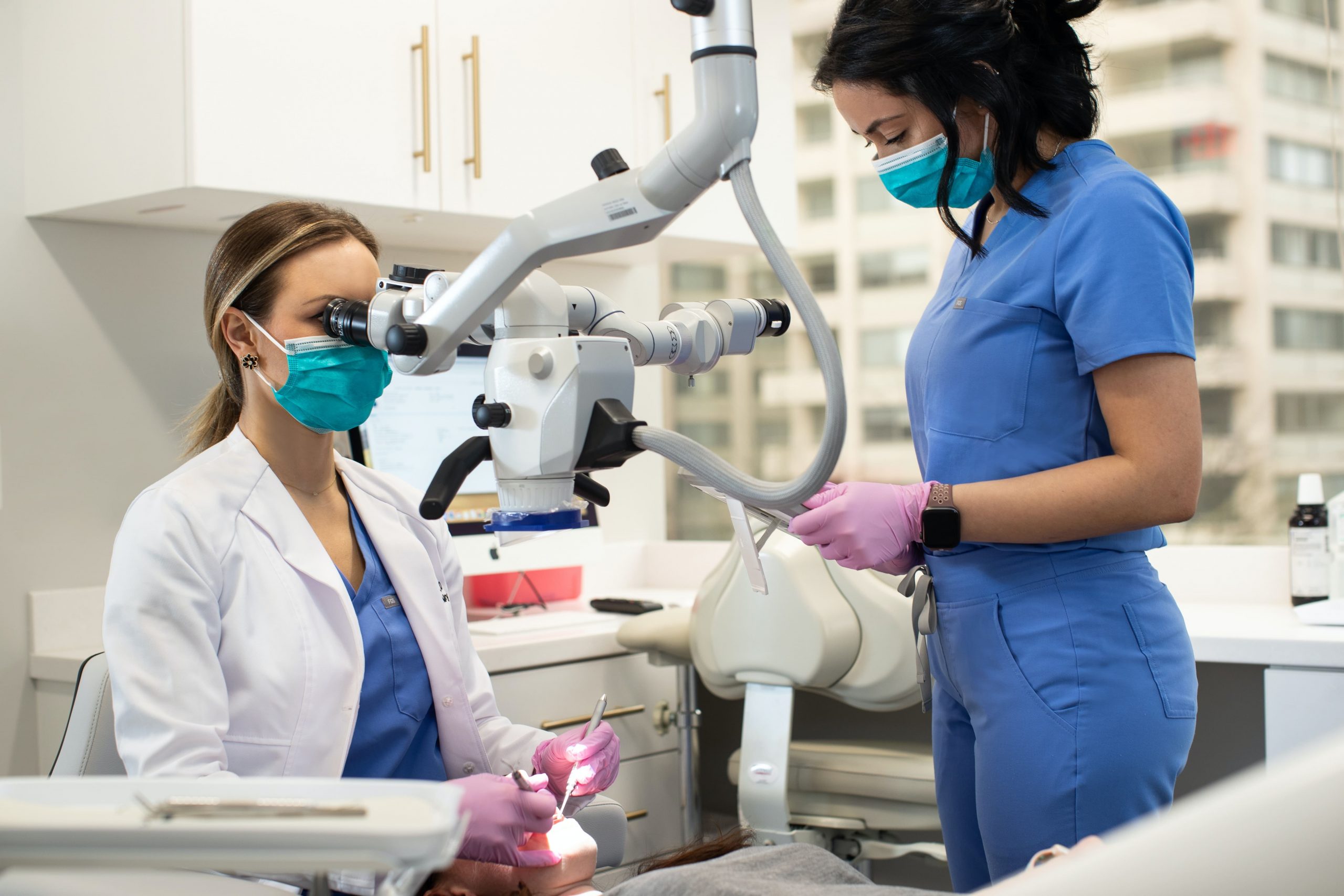 Photo dentist and dental hygienist performing an oral exam on a patient